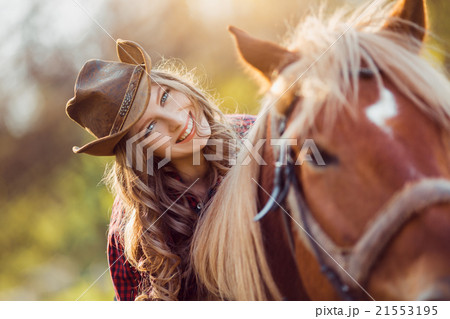 Cowgirl riding horse on summer field Cowgirl riding horse on summer field 21553195