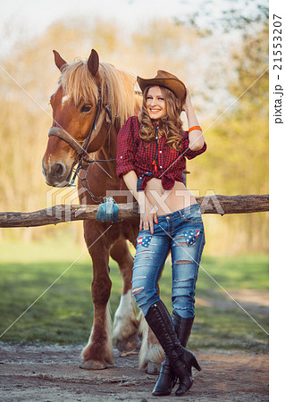 Horse and girl with cowboy hat 21553207