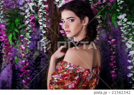 Pretty girl in magic wistaria garden 21562342