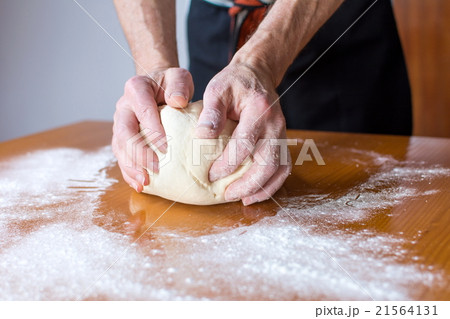 Baker makes bread on the table Baker makes bread on the table 21564131