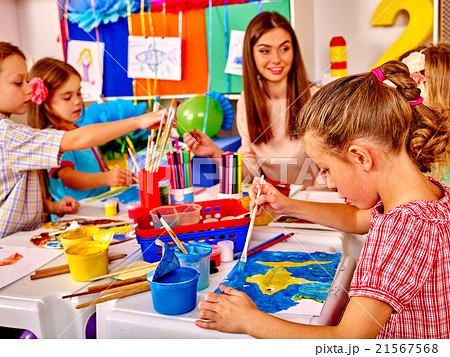 Children with teacher woman painting on paper in Children with teacher woman painting on paper in 21567568