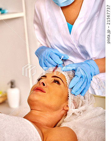 Woman middle-aged in spa salon with beautician 21567737