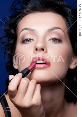Young Woman Applying Cosmetics Young Woman Applying Cosmetics 21569635