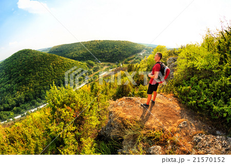 Active tourist on the top of mountain enjoying 21570152
