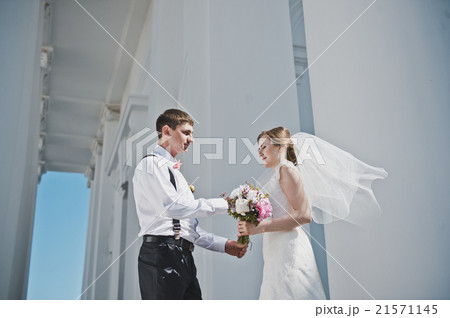 The groom hugging the bride with the white columns 3886. The groom hugging the bride with the white columns 3886. 21571145