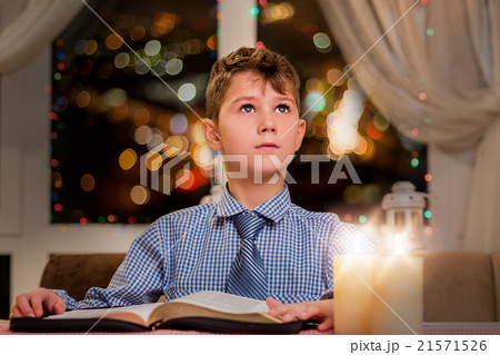 Child with book looking up. Child with book looking up. 21571526