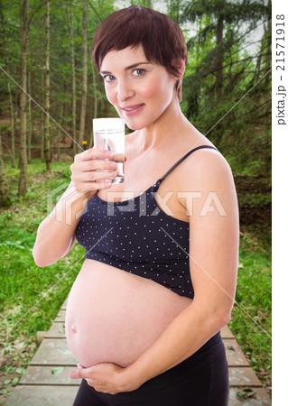 Composite image of pregnant woman drinking glass of water Composite image of pregnant woman drinking glass of water 21571918