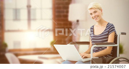 Composite image of woman in wheelchair using computer 21574007