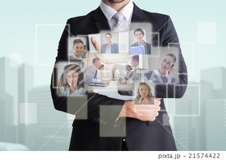 Composite image of mid section of businessman holding computer 21574422
