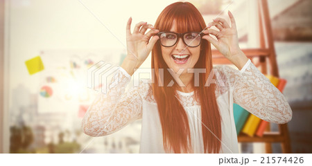 Composite image of smiling hipster woman posing face to the came Composite image of smiling hipster woman posing face to the came 21574426