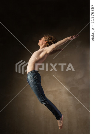 Young and stylish modern dancer on grey background Young and stylish modern dancer on grey background 21576867