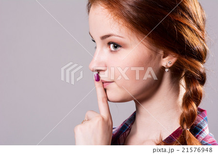 Psst - a beautiful girl with pigtails making  21576948