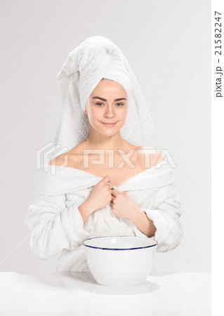 Woman cleaning face in bathroom 21582247