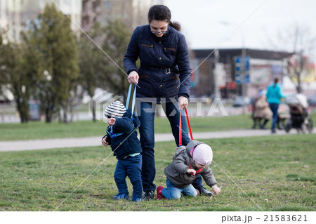 Mother walking with her two children off the leash Mother walking with her two children off the leash 21583621