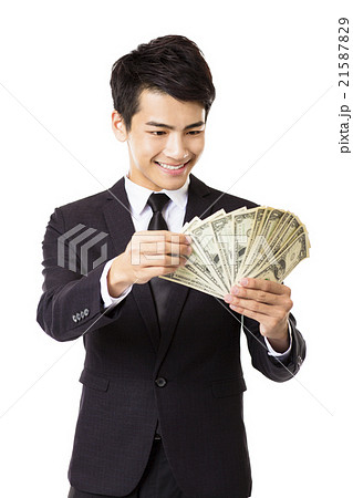 happy young business man holding money 21587829