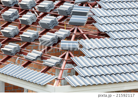 roof under construction with stacks of roof tiles roof under construction with stacks of roof tiles 21592117