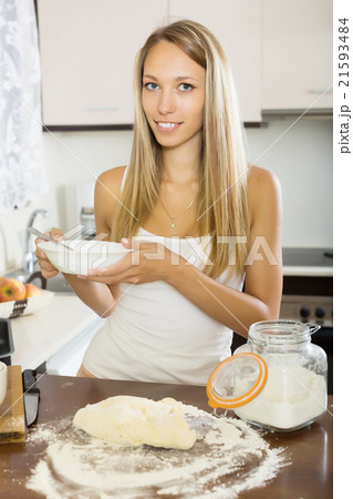 Smiling housewife cooking with dough 21593484