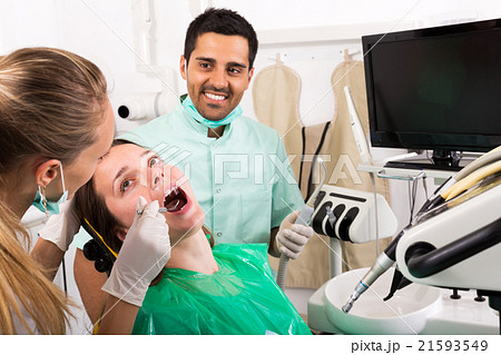 Dentist examines the oral cavity Dentist examines the oral cavity 21593549