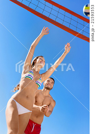 Young laughing couple playing volleyball 21593553