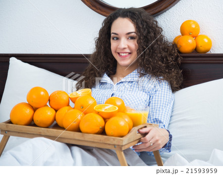 Positive girl with ripe oranges and glass of juice Positive girl with ripe oranges and glass of juice 21593959