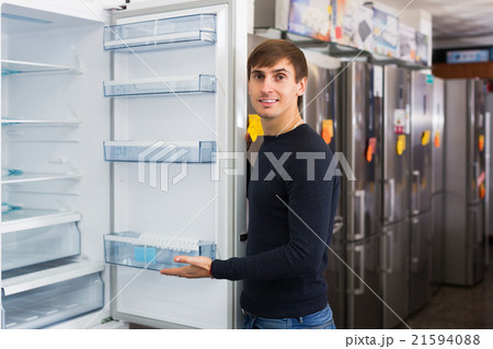 Man choosing new refrigerator Man choosing new refrigerator 21594088