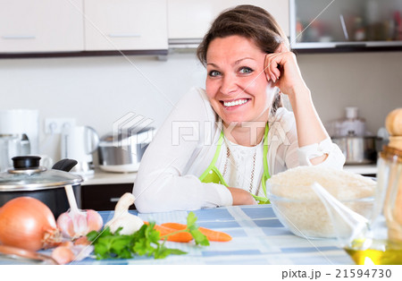 Portrait of smiling woman in kitchen Portrait of smiling woman in kitchen 21594730