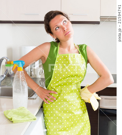 Unhappy young housewife cleaning furniture 21594741