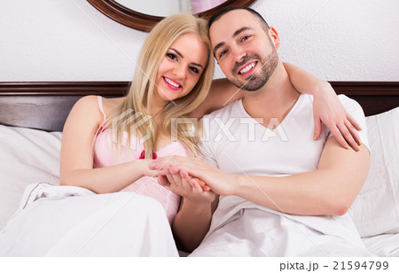 Couple posing in bed 21594799