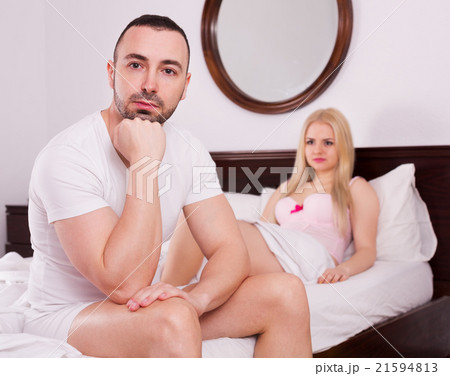 Wife and husband having difficulties in bed Wife and husband having difficulties in bed 21594813