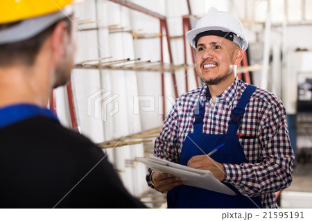 Mechanical engineer inspecting the work of labour at factory Mechanical engineer inspecting the work of labour at factory 21595191