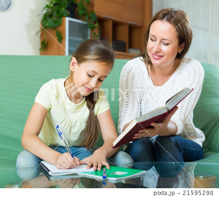 schoolgirl and mother doing homework 21595298