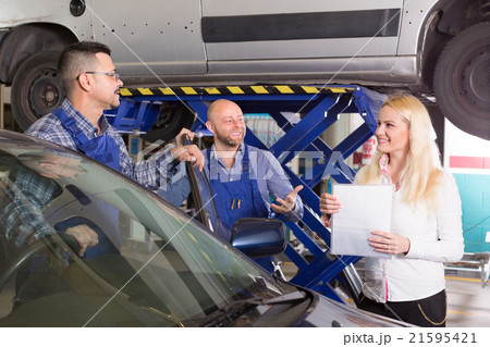 Woman and two auto mechanics 21595421