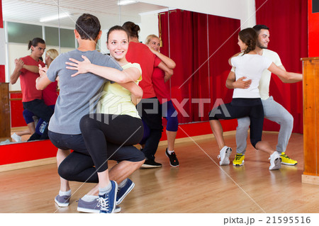 Group of people dancing salsa in studio 21595516