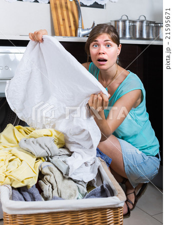 woman with dirty linen near washing machine woman with dirty linen near washing machine 21595671