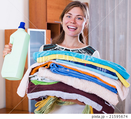 Housewife with stack of linen Housewife with stack of linen 21595674
