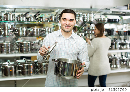Couple buying pans in shop cookware. Couple buying pans in shop cookware. 21595769