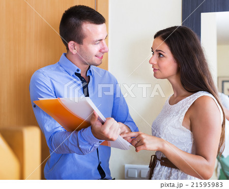 Seller showing documents indoors Seller showing documents indoors 21595983
