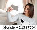 Portrait of a beautiful brunette taking a selfie 21597504