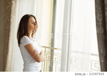 Portrait of a beautiful woman staying near the Portrait of a beautiful woman staying near the 21597505