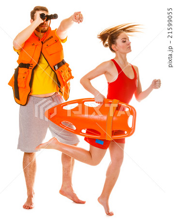 Lifeguards in life vest with rescue buoy running Lifeguards in life vest with rescue buoy running 21599055