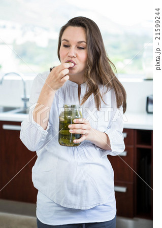 Pregnant woman eating pickles 21599244