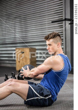 Muscular man training with medicine ball Muscular man training with medicine ball 21599281