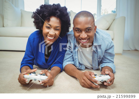 Smiling couple lying on the floor Smiling couple lying on the floor 21599899