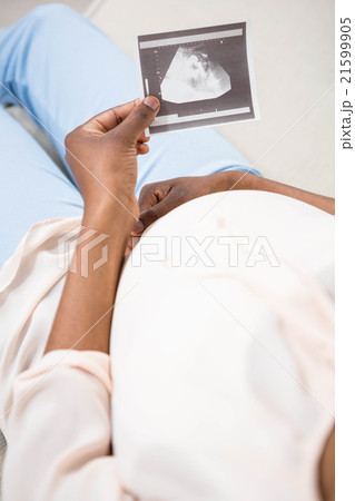 Pregnant woman holding ultrasound scan Pregnant woman holding ultrasound scan 21599905