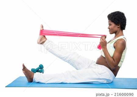 Pregnant woman doing exercise on mat Pregnant woman doing exercise on mat 21600090