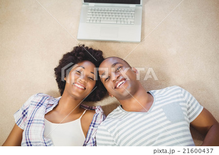 Happy couple lying on the floor 21600437