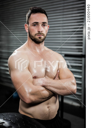 Serious shirtless man with arms crossed Serious shirtless man with arms crossed 21600440
