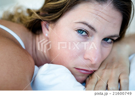 woman lying with her head on her hands looking sad 21600749