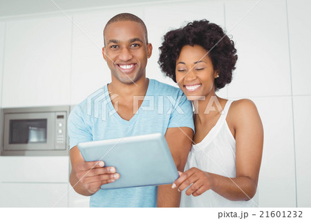 Smiling couple using tablet Smiling couple using tablet 21601232
