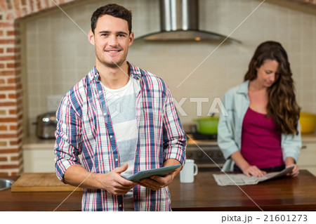 Man using tablet in kitchen Man using tablet in kitchen 21601273